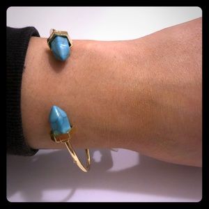 Gold cuff bracelet with turquoise stones